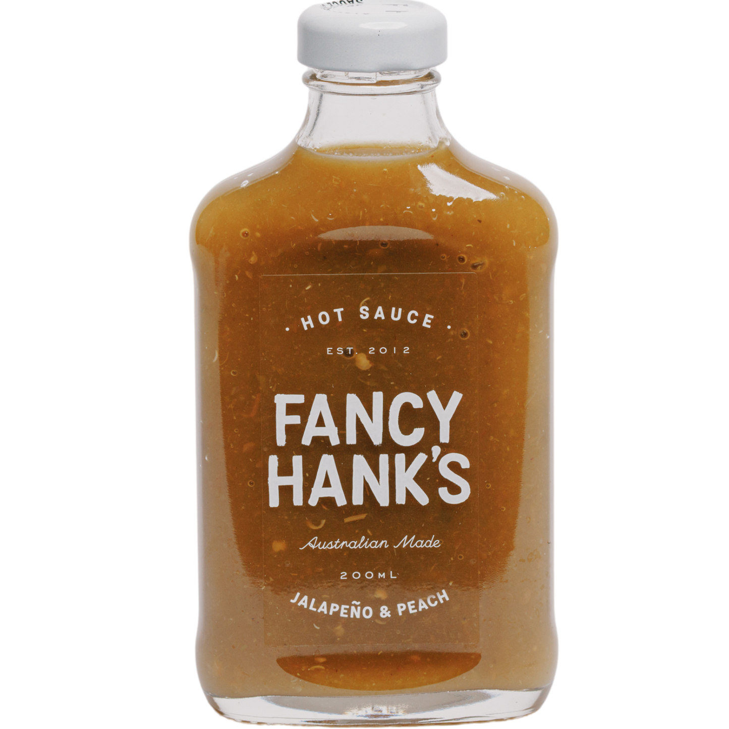 A bottle of Fancy Hank's hot sauce with the label showing 'Jalapeno & Peach' and the color of the sauce visible through the transparent bottle.
