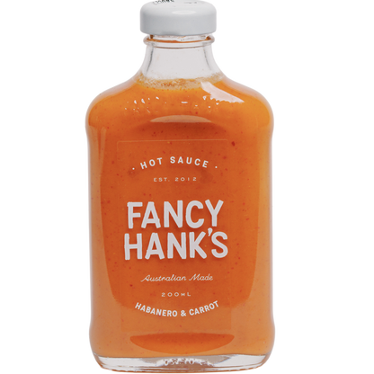 A bottle of Fancy Hank's Habanero & Carrot Hot Sauce